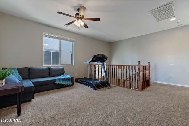 workout area with ceiling fan and carpet