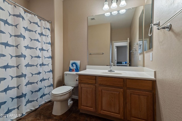 bathroom featuring toilet, a shower with curtain, and vanity