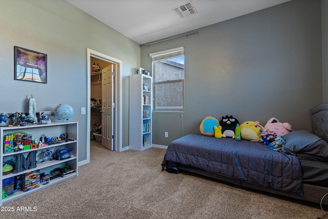 carpeted bedroom with a spacious closet