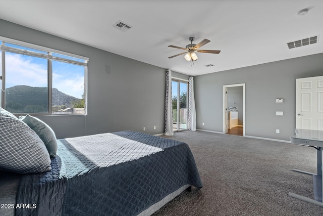 bedroom with ensuite bath, ceiling fan, carpet, and a mountain view