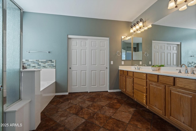 bathroom featuring a bath and vanity