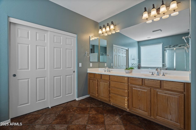 bathroom with walk in shower and vanity