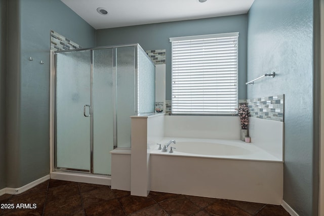 bathroom featuring shower with separate bathtub