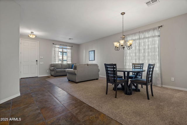 carpeted dining room with a notable chandelier