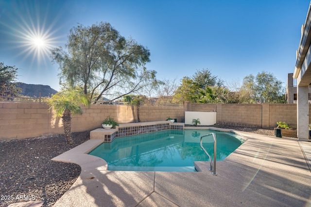 view of pool featuring a patio and a mountain view