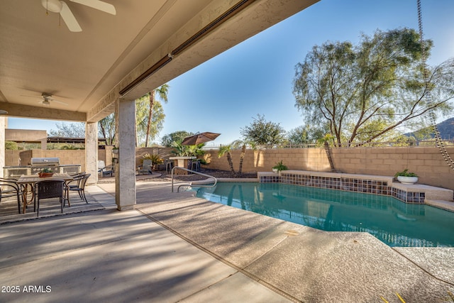 view of pool with a patio area, grilling area, and ceiling fan