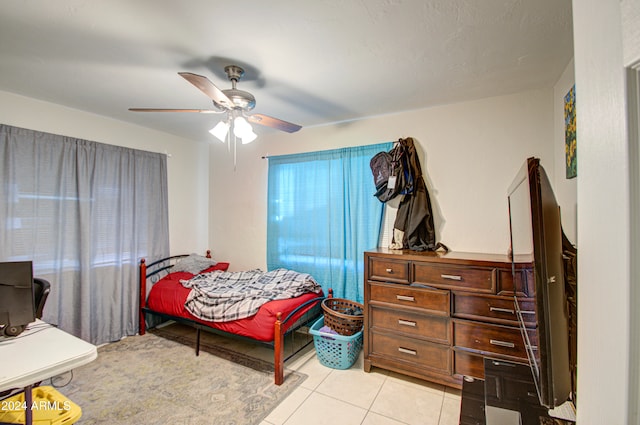 tiled bedroom with ceiling fan