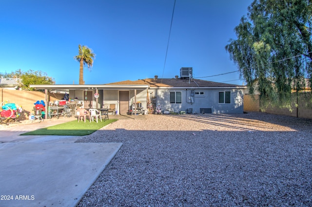 back of property featuring central AC unit and a patio