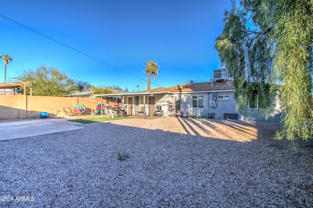 back of property featuring cooling unit and a patio