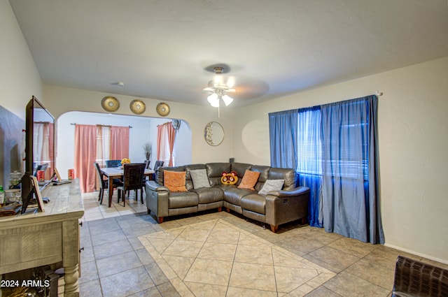 tiled living room featuring ceiling fan