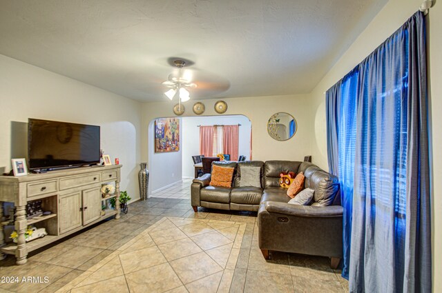 living room with ceiling fan and light tile patterned floors