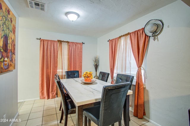 dining area featuring light tile patterned floors