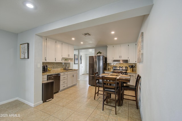 kitchen featuring sink, stainless steel fridge, dishwasher, white cabinets, and backsplash