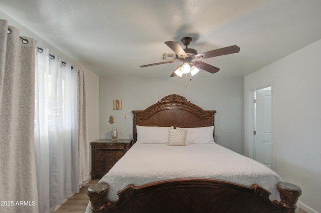 bedroom with ceiling fan and light wood-type flooring