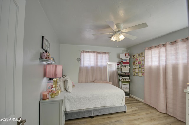 bedroom with light hardwood / wood-style floors and ceiling fan