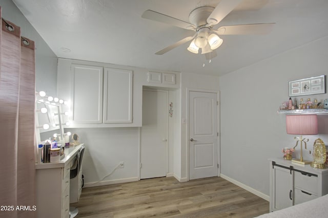 interior space featuring white cabinetry, ceiling fan, and light hardwood / wood-style flooring