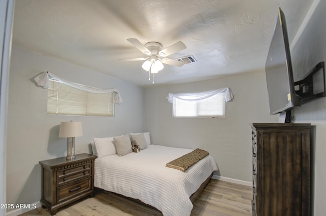 bedroom with ceiling fan and light wood-type flooring