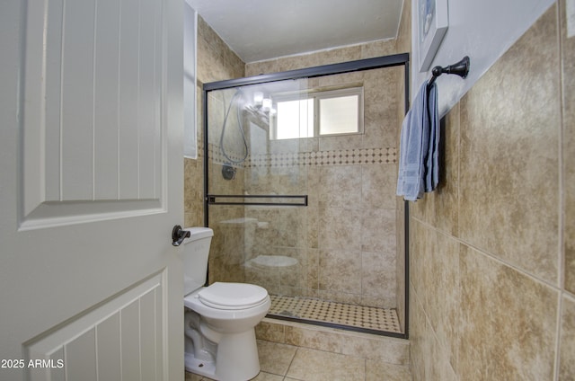 bathroom with an enclosed shower, tile patterned floors, and toilet