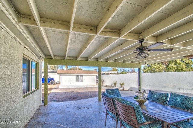 view of patio / terrace with ceiling fan and an outdoor structure