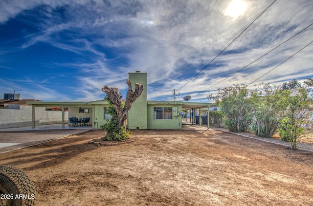 rear view of house with a carport