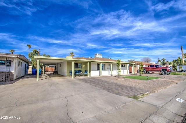 ranch-style home featuring a carport