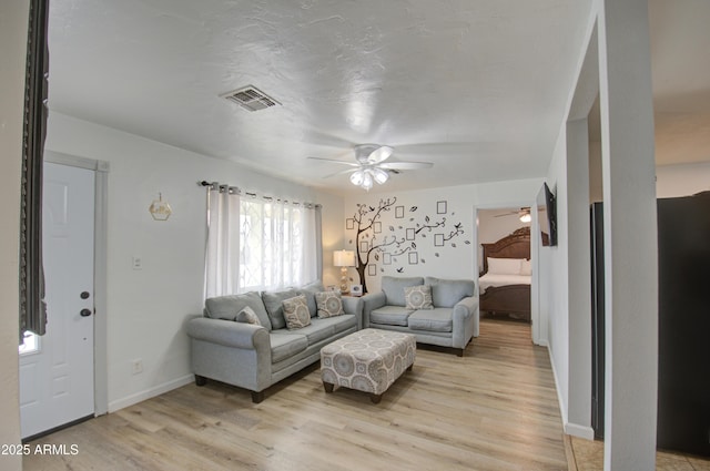 living room with ceiling fan and light wood-type flooring