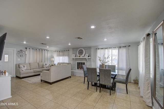 tiled dining area featuring a fireplace