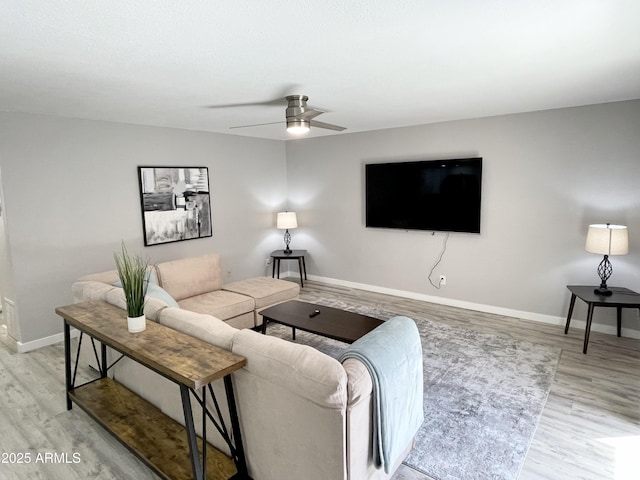 living room with light wood-type flooring and ceiling fan