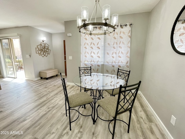 dining room with a notable chandelier and light hardwood / wood-style floors