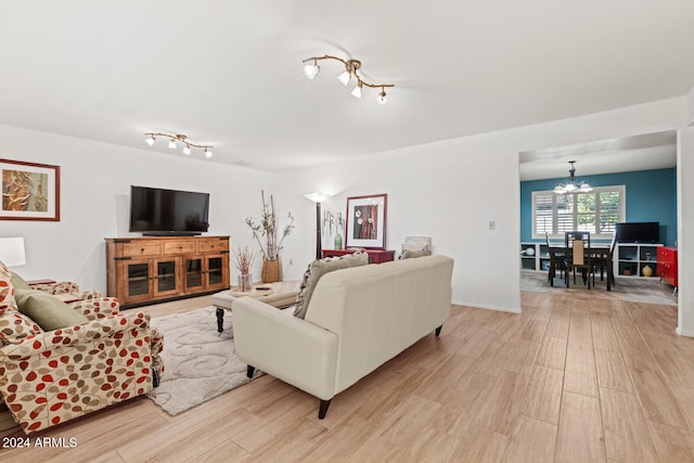 living room featuring light hardwood / wood-style flooring and a chandelier