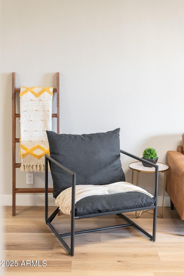 sitting room featuring baseboards and wood finished floors