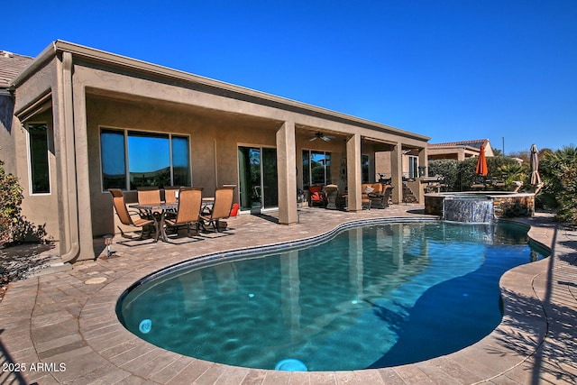 view of swimming pool featuring a patio area and an in ground hot tub