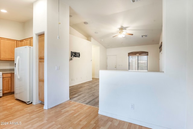 kitchen with white fridge with ice dispenser, lofted ceiling, ceiling fan, and light hardwood / wood-style flooring