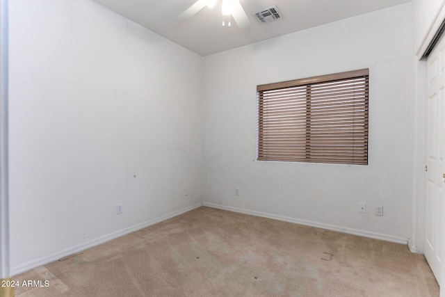 empty room with light carpet and ceiling fan