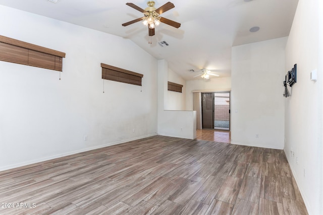 spare room featuring light hardwood / wood-style floors, lofted ceiling, and ceiling fan