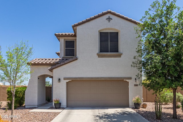 19561 W Woodlands Ave, Buckeye, AZ 85326 - mediterranean / spanish home featuring concrete driveway, stucco siding, a tile roof, a garage, and fence