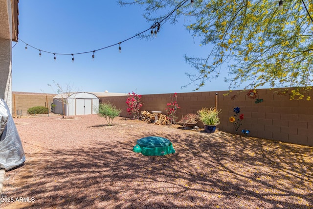 19561 W Woodlands Ave, Buckeye, AZ 85326 - view of yard with an outbuilding, a storage unit, and a fenced backyard