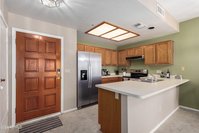 kitchen featuring sink, appliances with stainless steel finishes, kitchen peninsula, and a textured ceiling