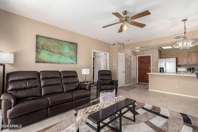 living room featuring ceiling fan with notable chandelier and light carpet