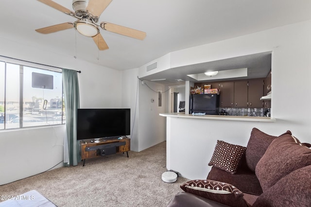 carpeted living room featuring ceiling fan