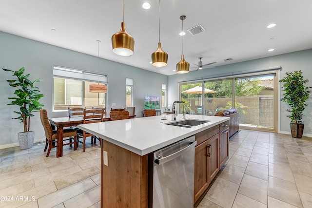 kitchen with a kitchen island with sink, ceiling fan, sink, pendant lighting, and dishwasher