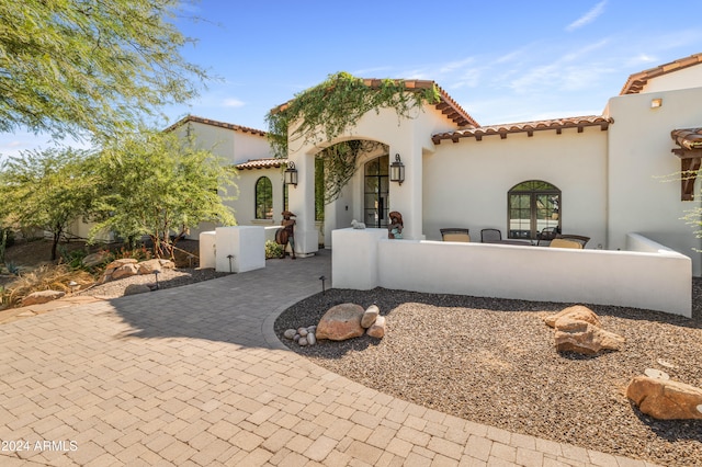 mediterranean / spanish-style house with a patio area