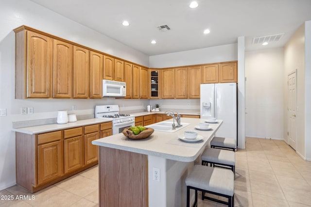 35402 N 32nd Dr, Phoenix, AZ 85086 - kitchen featuring white appliances, light countertops, light tile patterned floors, a center island with sink, and recessed lighting