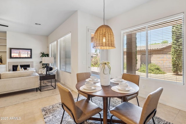 35402 N 32nd Dr, Phoenix, AZ 85086 - dining room with light tile patterned flooring and a tile fireplace