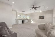 living room featuring carpet and ceiling fan