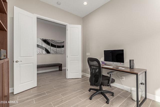 office space with wood-type flooring and vaulted ceiling