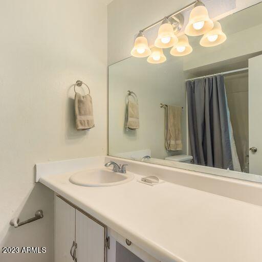 bathroom with vanity, toilet, and a shower with shower curtain