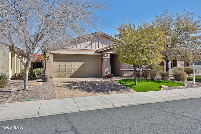 view of front of house with a garage and decorative driveway