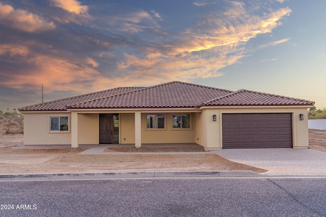 view of front of house featuring a porch and a garage