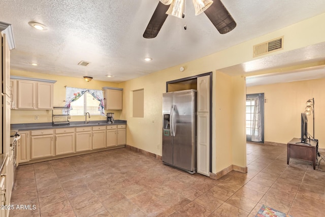 1302 E Forge Ave, Mesa, AZ 85204 - kitchen with plenty of natural light, cream cabinetry, stainless steel fridge with ice dispenser, visible vents, and a sink
